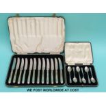 A cased set of 12 butter knives with hallmarked silver handles and six cased hallmarked silver