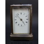 A late 19thC carriage clock with repeating mechanism striking on a bell,