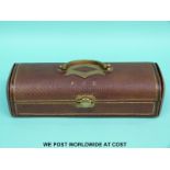 A tooled leather and gilt metal mounted glove box opening to reveal a padded silk interior,