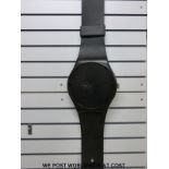 A black Swatch wall watch (26 cm diameter dial)