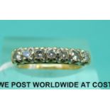 An 18ct gold ring set with seven diamonds (size L)