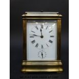 A late 19th / early 20th century brass carriage clock with repeat hourly mechanism striking on a