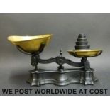 A set of cast iron and brass kitchen or shop scales and weights