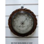 A Mappin & Webb carved oak cased circular aneroid barometer (16cm diameter dial)