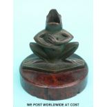 An Art Deco bronze figural frog pen holder or inkwell mounted on a burr walnut circular base.