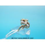 A 14ct gold ring set with six opals and two diamonds