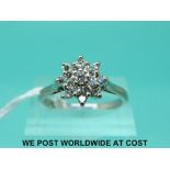 An 18ct white gold ring set with a cluster of diamonds (size Q)