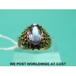 A yellow metal ring marked 333 set with an amethyst (size N)