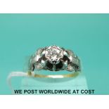 An 18ct gold ring set with a round brilliant cut diamond in a platinum setting (size R)