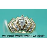 A yellow metal ring marked 14k set with an emerald cut diamond to the centre,