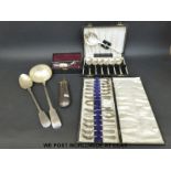 An Elkington & Co plated basting spoon, a cased set of 12 spoons, a ladle,