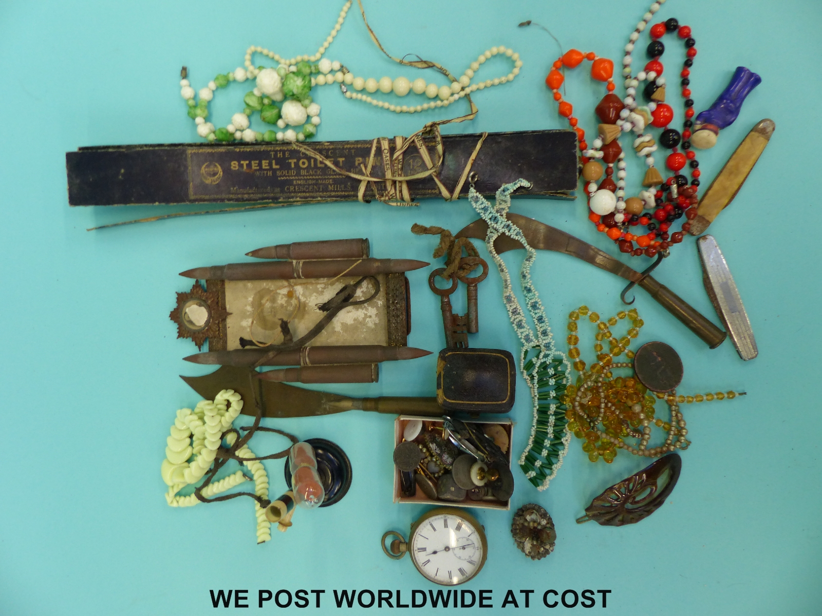 A quantity of costume jewellery, pocket watch, hat pins, WWI trench art, glass beads,