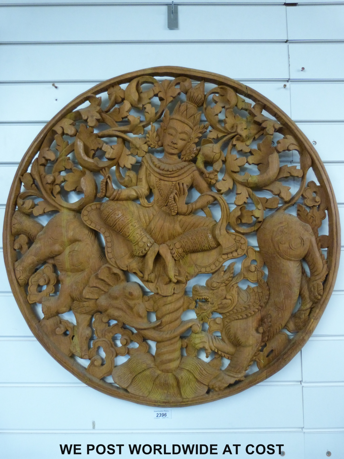 A carved circular Tibetan or similar wooden panel (75cm diameter)