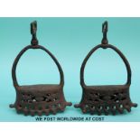 A pair of 17th/18thC Spanish or Portuguese pierced iron stirrups with various correspondence from