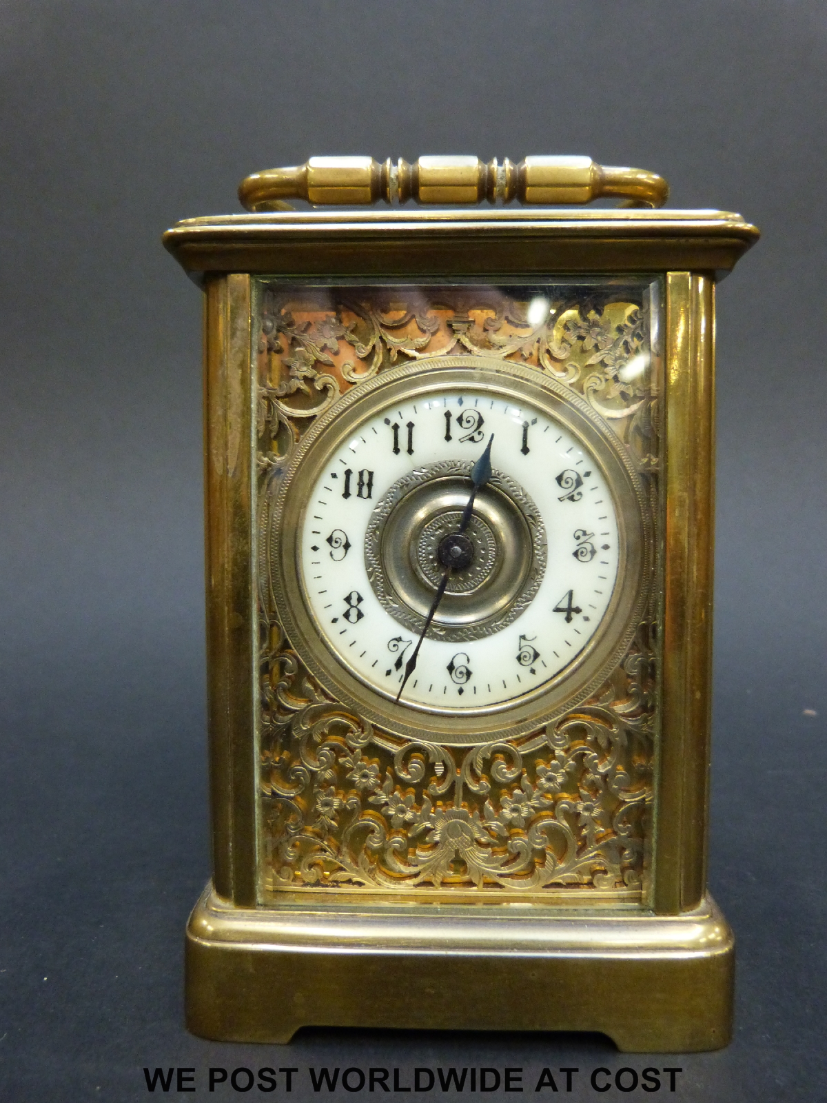A late 19th/early 20thC brass cased carriage clock with ivory coloured enamel chapter ring,