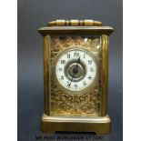 A late 19th/early 20thC brass cased carriage clock with ivory coloured enamel chapter ring,