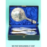 A hallmarked silver dressing table set comprising hand mirror, four brushes and comb, in fitted box,