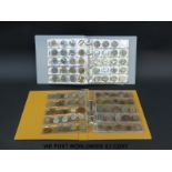 Two collectors coin folders, one containing overseas examples with small silver content,