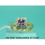 An 18ct gold ring set with an amethyst surrounded by diamonds in a square setting (size L)