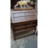 A 1930s oak bureau on stand, 89cm wide.