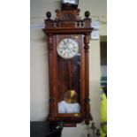 A late 19th century walnut Vienna style wall clock, by Gustav Becker, with weight driven movement,