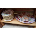 A set of three early 19th century English porcelain Imari dinner plates; with matching oval dish;