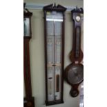 A reproduction mahogany Admiral Fitzroy barometer.