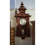 An early 20th century walnut and oak wall clock.