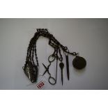 A Georgian steel chatelaine, with attached scissors, bodkin, stiletto,