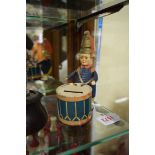 A Schuco tin plate clockwork drummer money box, 16cm high.