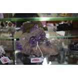 An unusual carved amethyst crystal frog figure group, 16.5cm wide.