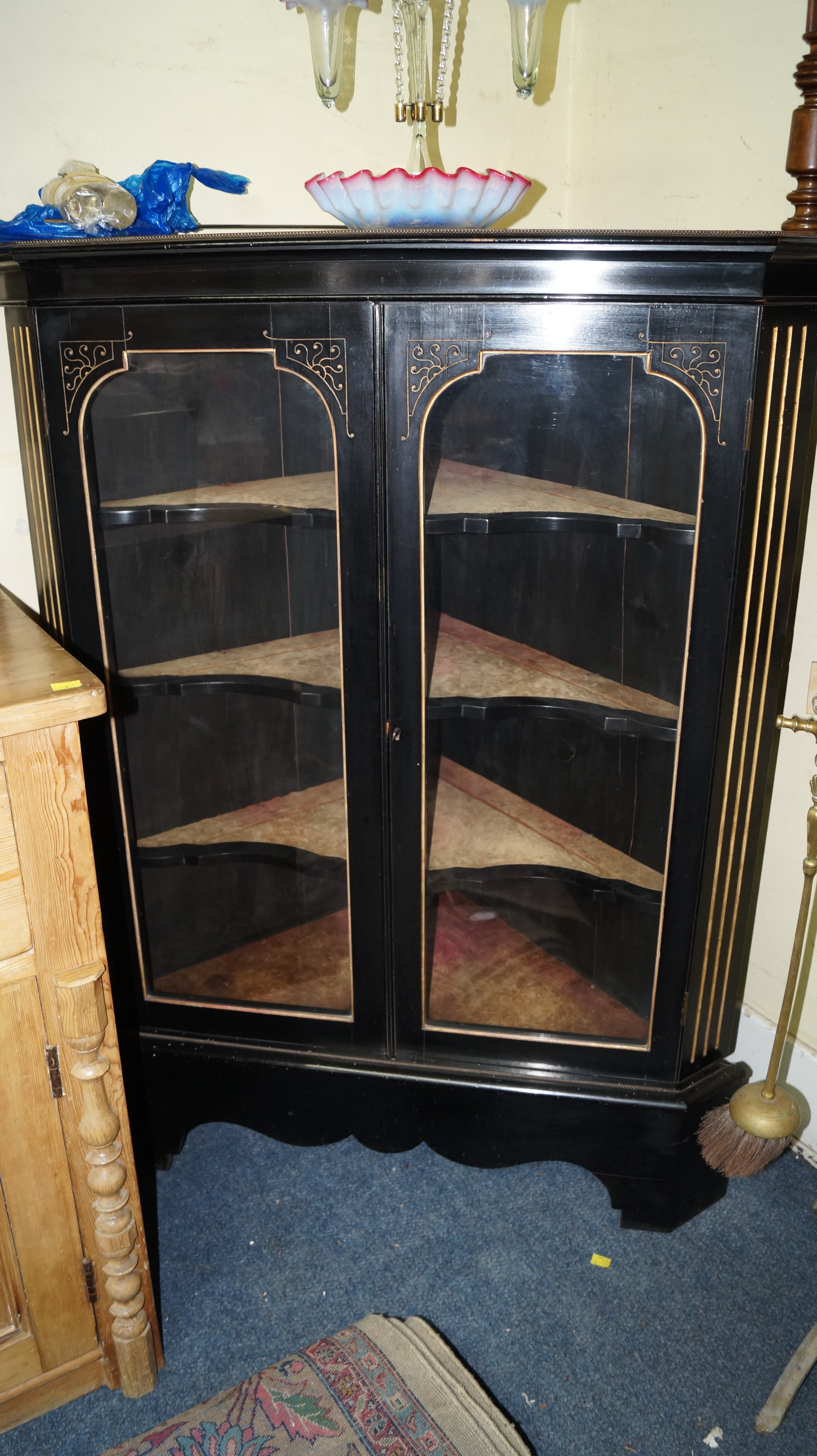 A late 19th century ebonized corner display cabinet, 130cm high x 97cm wide.
