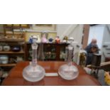 A pair of Edwardian clear glass globe and shaft decanters and stoppers.