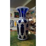 A late 19th century Bohemian blue glass and white overlaid vase, with gilt decoration, 25cm high.