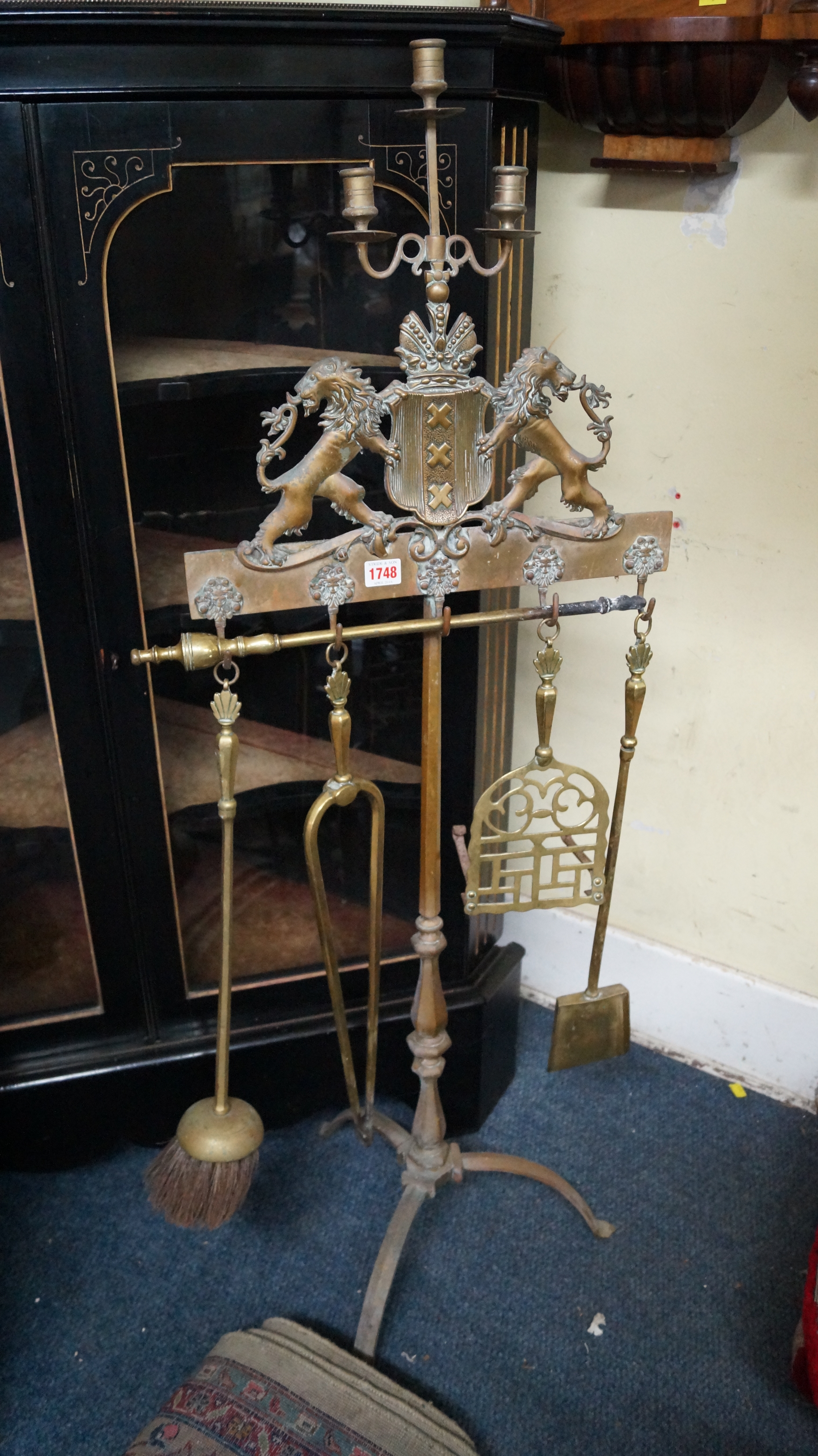 An antique brass tripod fire iron stand, with three branch candlestick surmount, 126.5cm high.