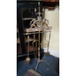 An antique brass tripod fire iron stand, with three branch candlestick surmount, 126.5cm high.