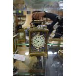 An old brass and champleve enamel carriage timepiece, height including handle 12.5cm.