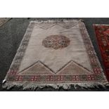 A Moroccan cream ground rug, having central motif with panelled border, 202 x 151cm.