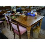 An antique pine large kitchen table, with two lateral frieze drawers to one end, 227.5cm long.