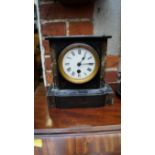 A slate and marble mantel timepiece, 21cm high.