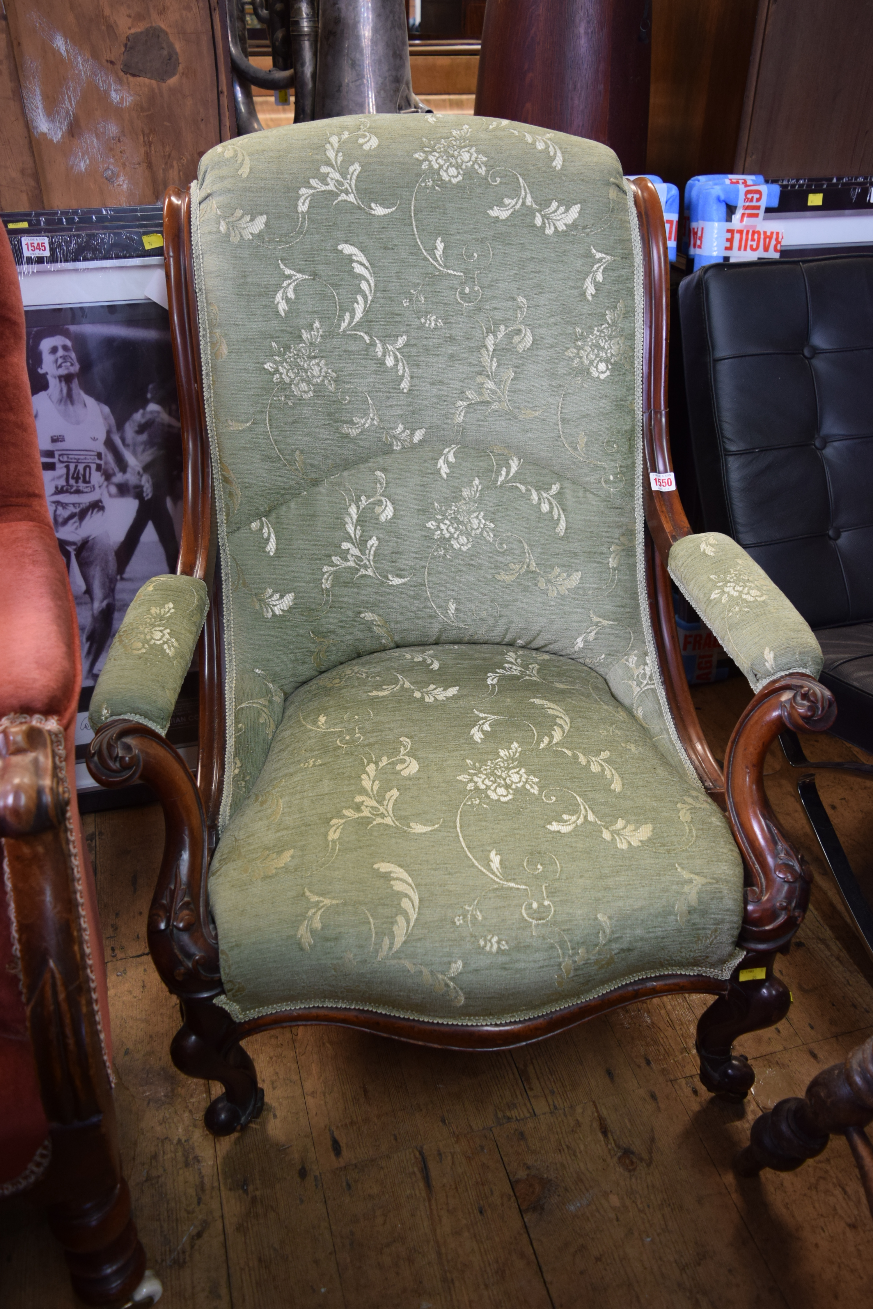 A carved mahogany framed and upholstered occasional chair.