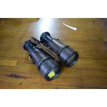 A pair of antique military field binoculars, with broad arrow.