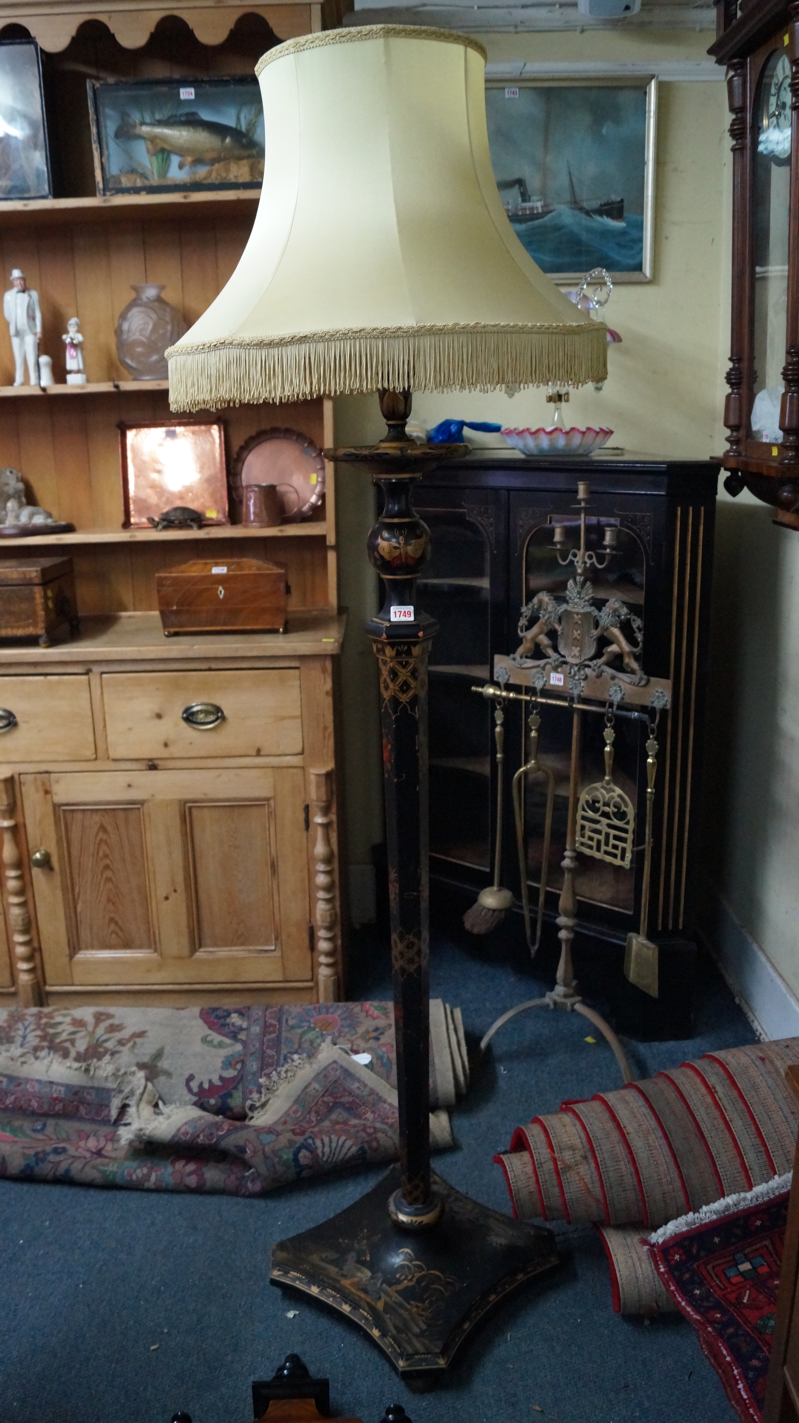 An old black lacquered and gilt chinoiserie standard lamp.