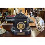 A late Victorian slate mantel clock, of architectural form, bearing gilt brass plaque inscribed '...