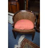 A pair of late 19th/early 20th century American oak and cane tub chairs,