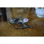 An early 20th century cold painted figure group of two birds on a branch, stamped Geschutz,