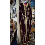 A burgundy and gilt embroidered full length robe.