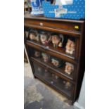 An early 20th century oak three tier sectional bookcased, labelled George Fleet & Co Ltd, 87cm wide.