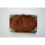 An early 20th century continental .925 silver mounted crocodile skin wallet, approx 14 x 9.5cm.