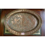 An Eastern copper oval tray, decorated with figures, 43cm wide.